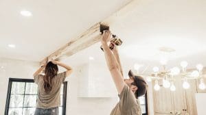 Installing Faux Wood Beams on Your Ceiling: Screwing the beam in