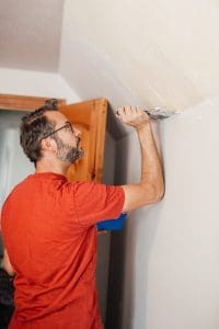 Skimming a textured wall before hanging wallpaper