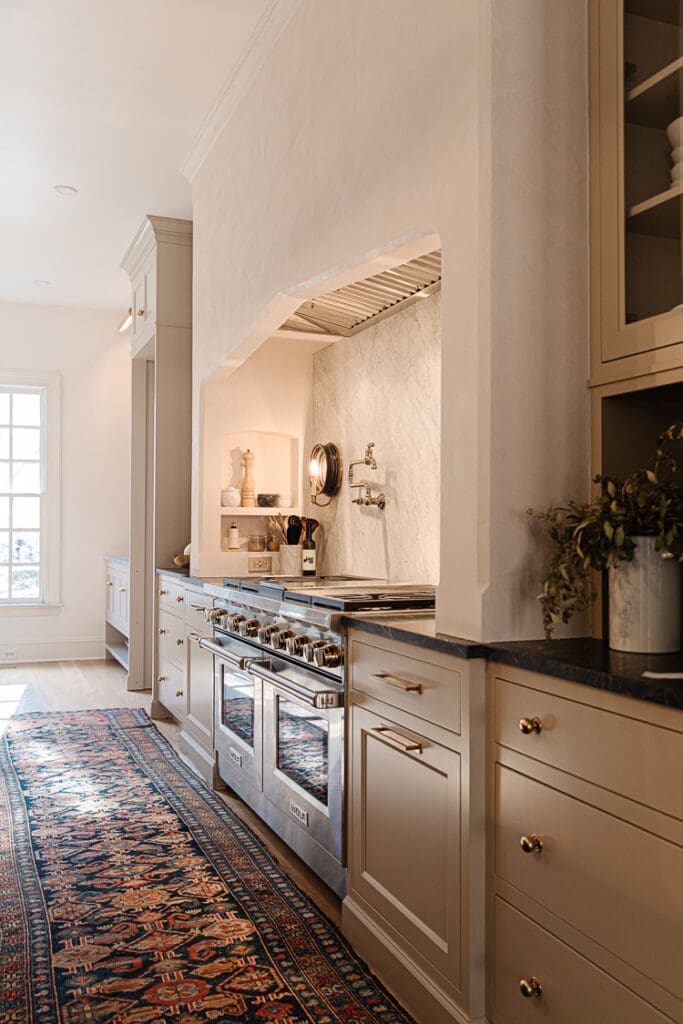 A side angle of a modern traditional plastered hood over the kitchen range