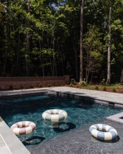 Soft colorful pool floats in a backyard pool