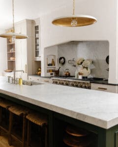 Long marble countertop on a dark green island