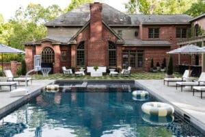 Beautiful backyard featuring a swimming pool, lounge chairs, and shaded seating areas for outdoor gatherings.