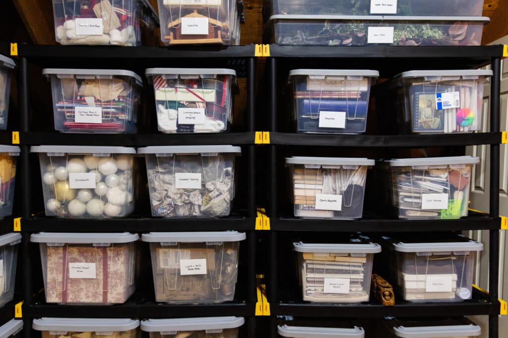 Clear bins with labels on attic shelves