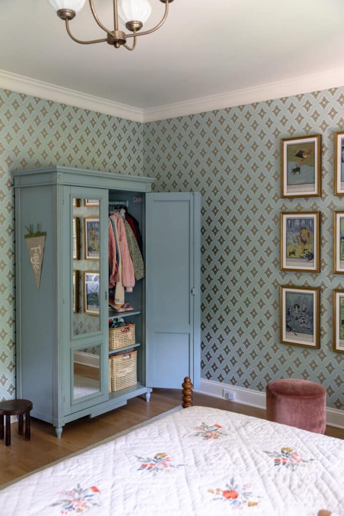 Chris Loves Julia | Blue painted armoire filled with clothes in a child's bedroom