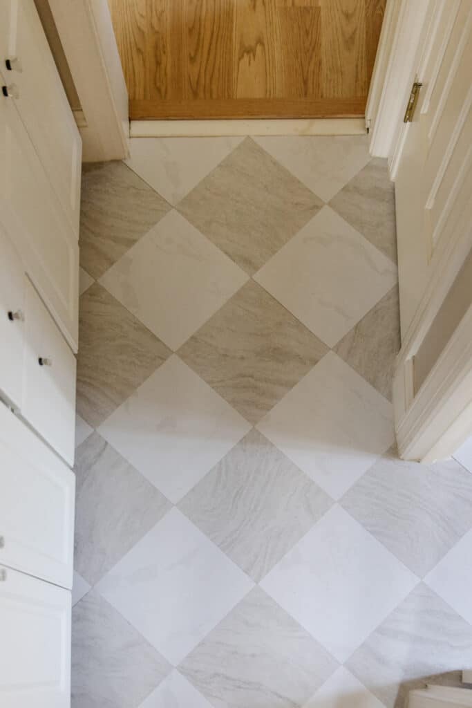 Marble tile flooring with a diamond pattern in a bright, inviting hallway.