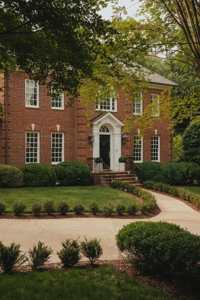 Moody Colonial Brick Home with White Paint Trim