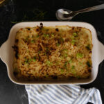 Delicious dairy-free scalloped potatoes baked with a creamy sauce, topped with green onions, perfect for gluten-free and grain-free diets.