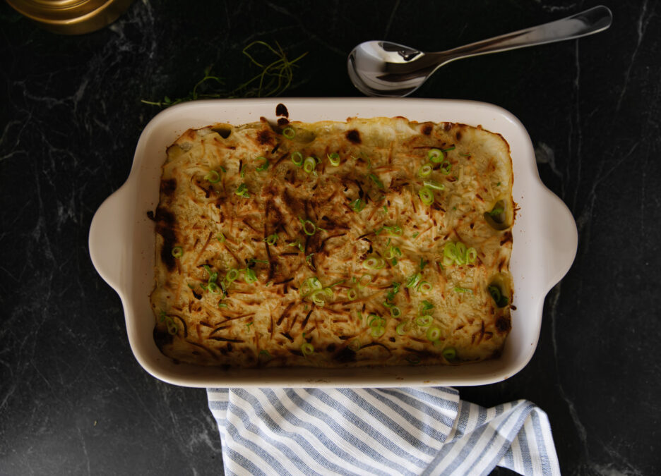 Delicious dairy-free scalloped potatoes baked with a creamy sauce, topped with green onions, perfect for gluten-free and grain-free diets.