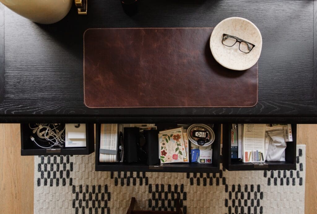 Chris Loves Julia | Overhead view of kitchen desk drawers with electronic supplies, stationary supplies and notepads