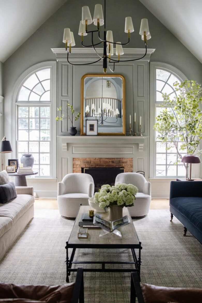 The living room with original white arched windows flanking the fireplace