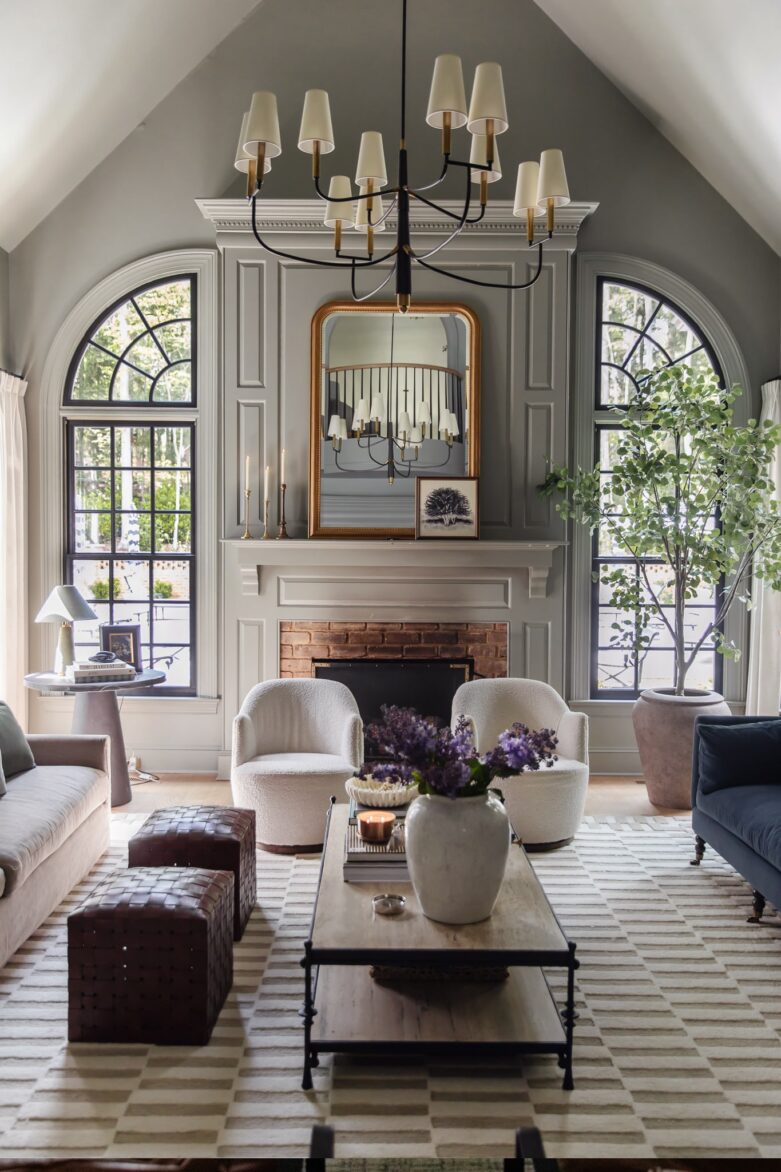 The living room with new black arched windows flanking the fireplace
