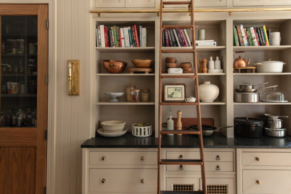 Bright, organized kitchen shelving with ceramic bowls, books, and decorative items for stylish storage and home decor.
