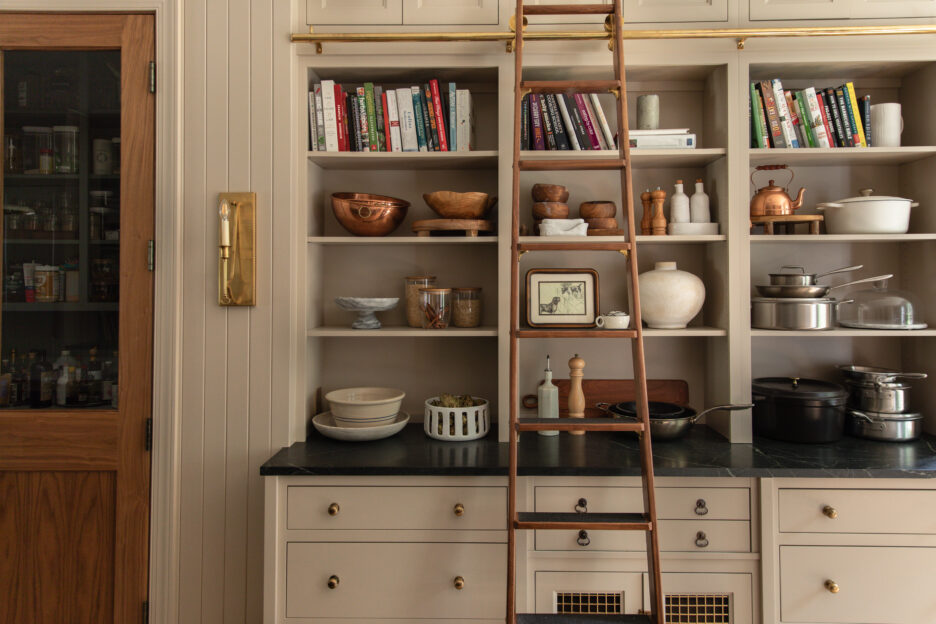 Bright, organized kitchen shelving with ceramic bowls, books, and decorative items for stylish storage and home decor.