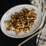 Delicious roasted cauliflower topped with homemade dairy-free Caesar dressing, perfect for a healthy, flavorful side dish or snack.