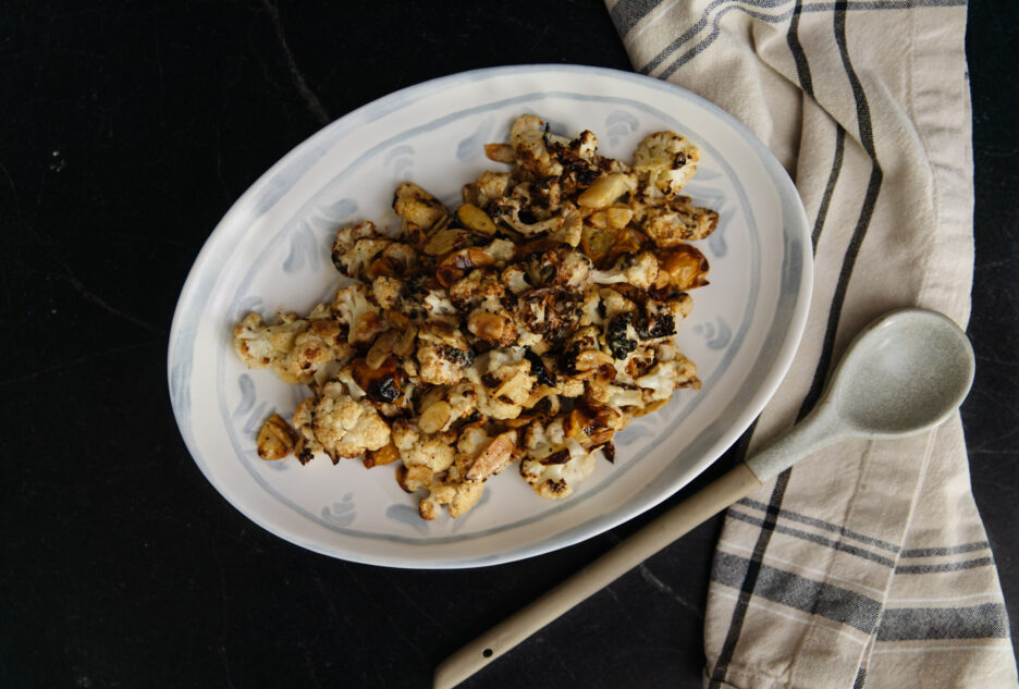 Delicious roasted cauliflower topped with homemade dairy-free Caesar dressing, perfect for a healthy, flavorful side dish or snack.