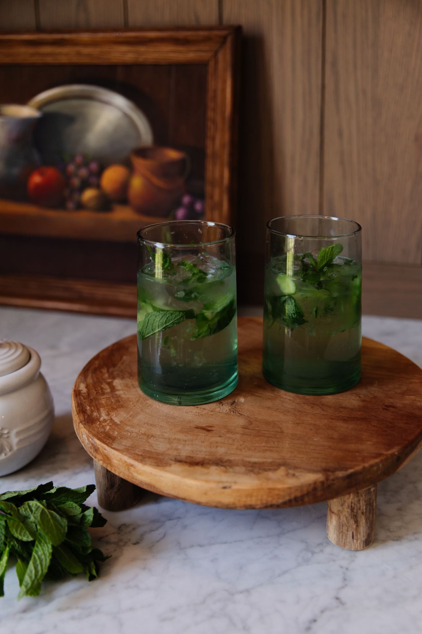 Virgin Mojito with Cucumber and Honey Nojito, refreshing non-alcoholic drink featuring fresh mint, cucumber slices, and honey, served in clear glasses on a rustic wooden tray.