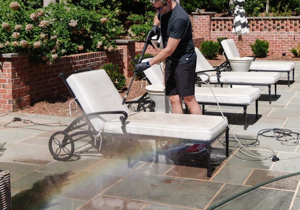 Chris Loves Julia | Chris power-washing the lounge chairs by the pool