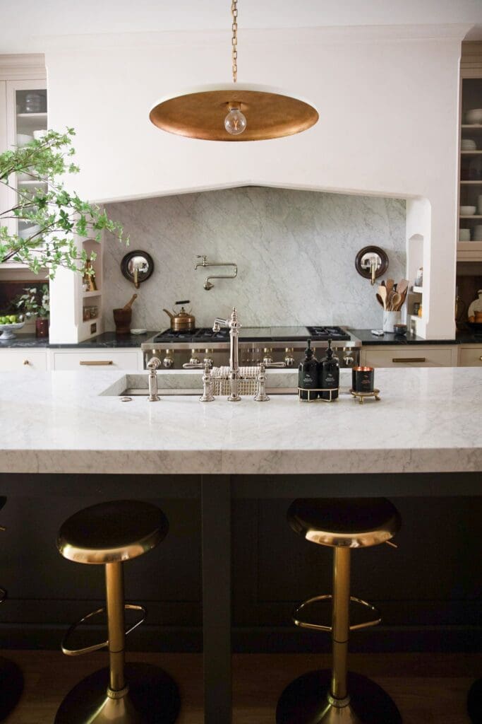 Chris Loves Julia | Gold bar stools at kitchen island