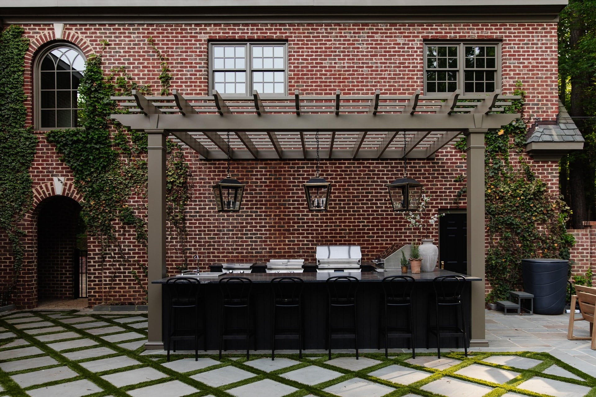 Chris Loves Julia | Outdoor Kitchen with Moody Brown Pergola