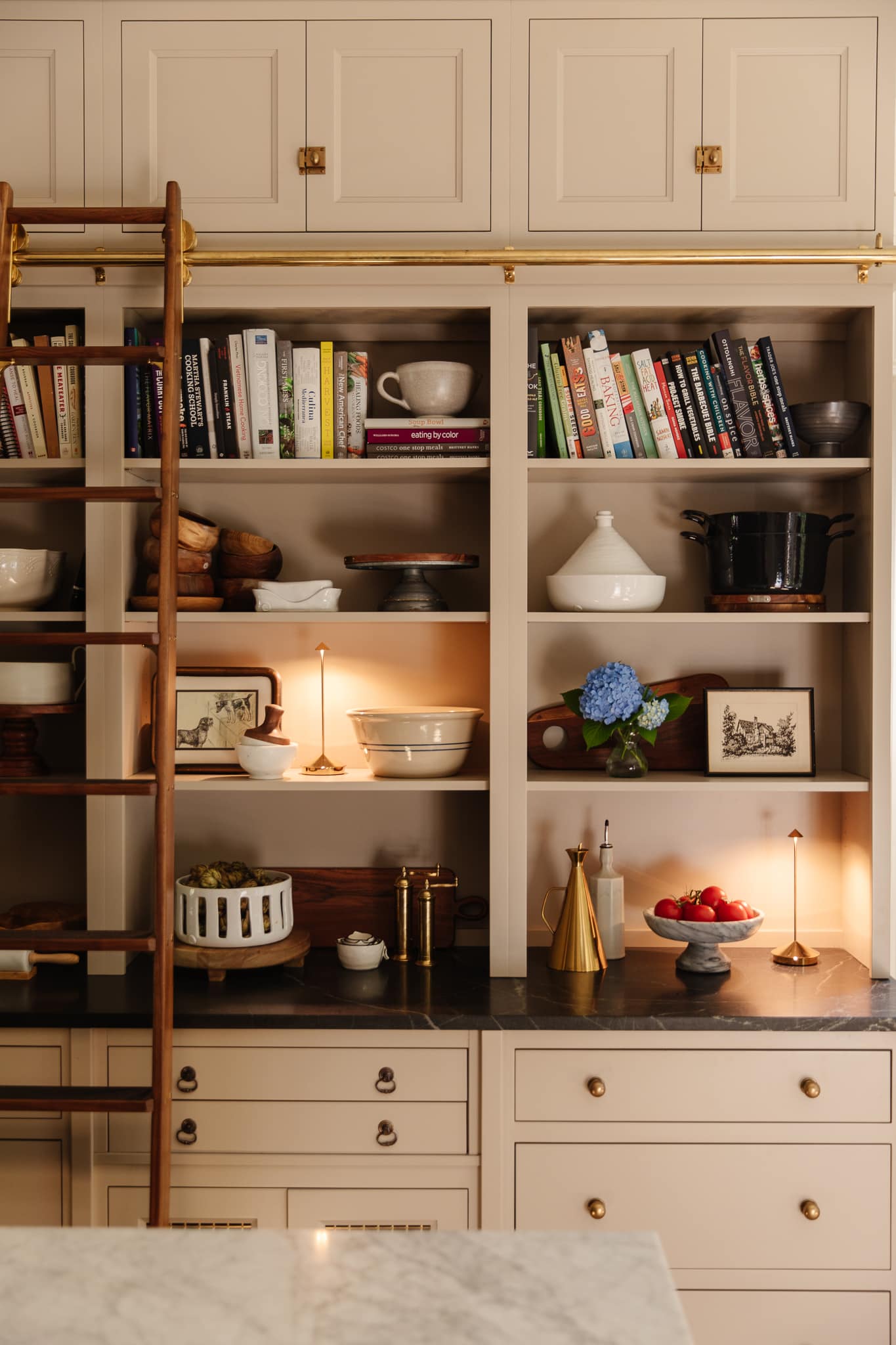 Chris Loves Julia | A small electric candle lit on kitchen shelves