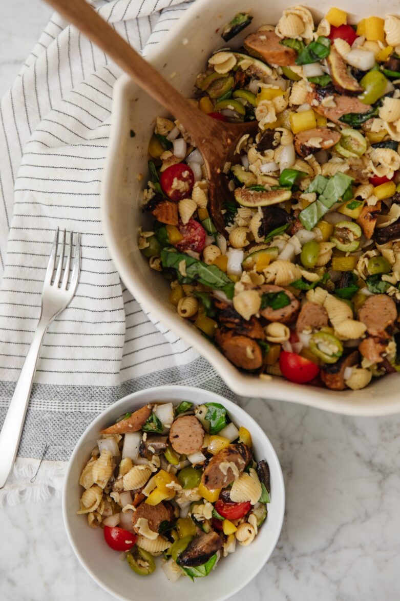 Delicious pasta salad featuring sliced sausage, cherry tomatoes, celery, and bell peppers, tossed in a flavorful dressing. Perfect for summer gatherings or quick weeknight dinners.