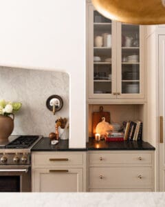 A moody, modern, traditional kitchen with a lit candle