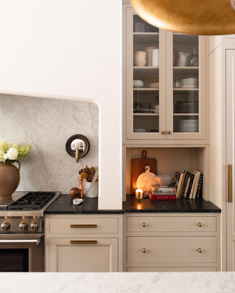A moody, modern, traditional kitchen with a lit candle