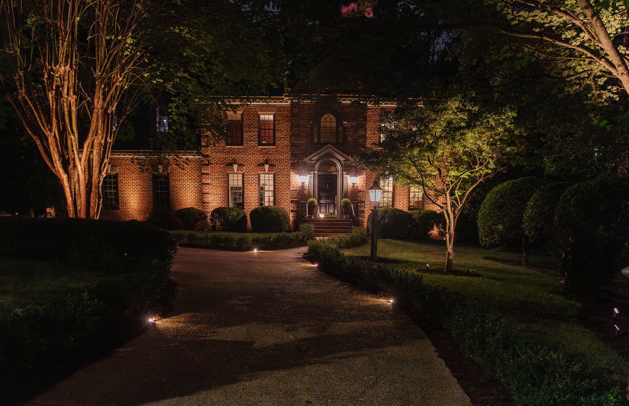 Chris Loves Julia | Modern Colonial house front exterior with landscape lighting at night