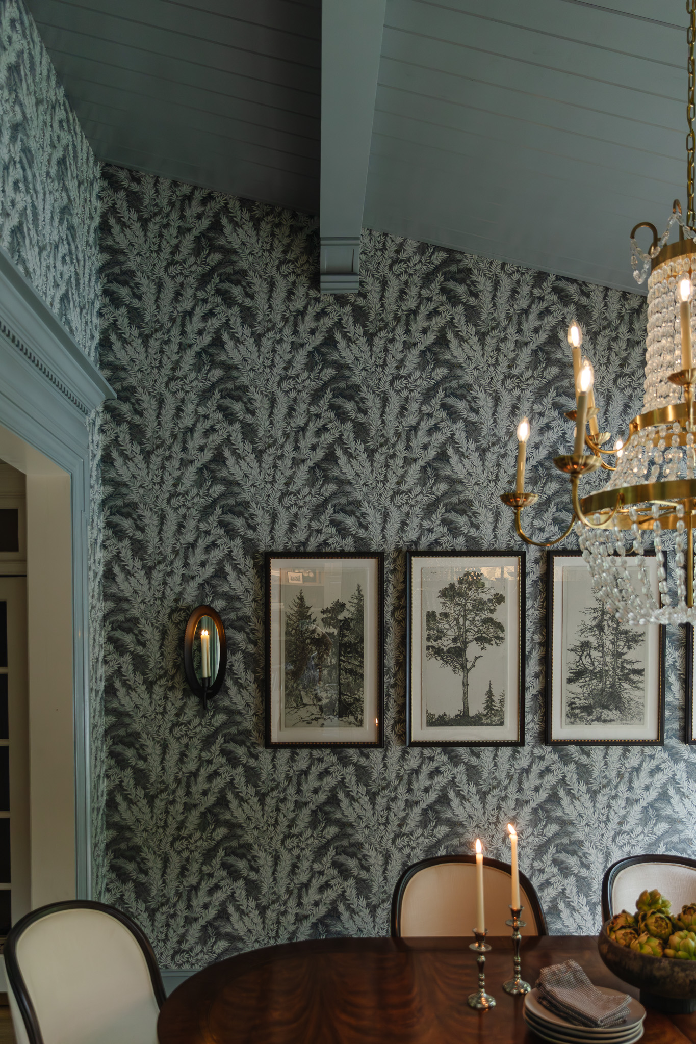 Painted planking, ceiling beams, and corbels in a smoky gray-blue color above a dining room