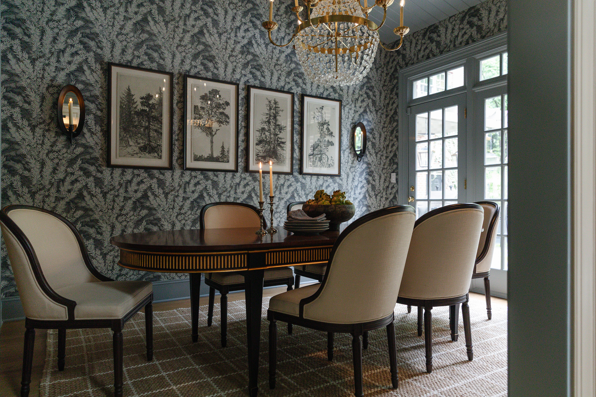 Charming dining area featuring a round table, upholstered chairs, and vintage wall art, perfect for family gatherings and entertaining guests.