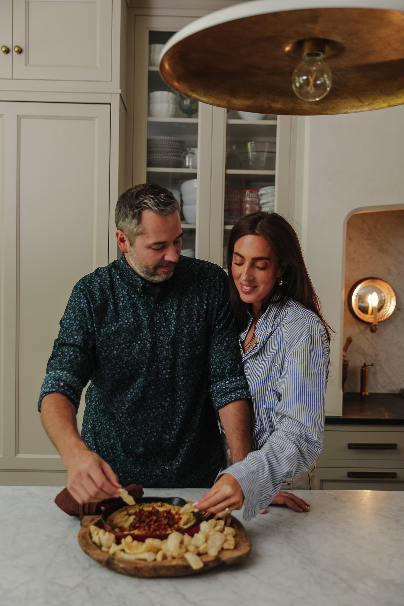 Chris Loves Julia | Chris and Julia digging into a bowl of Skillet White Bean Dip with Spicy Italian Sausage