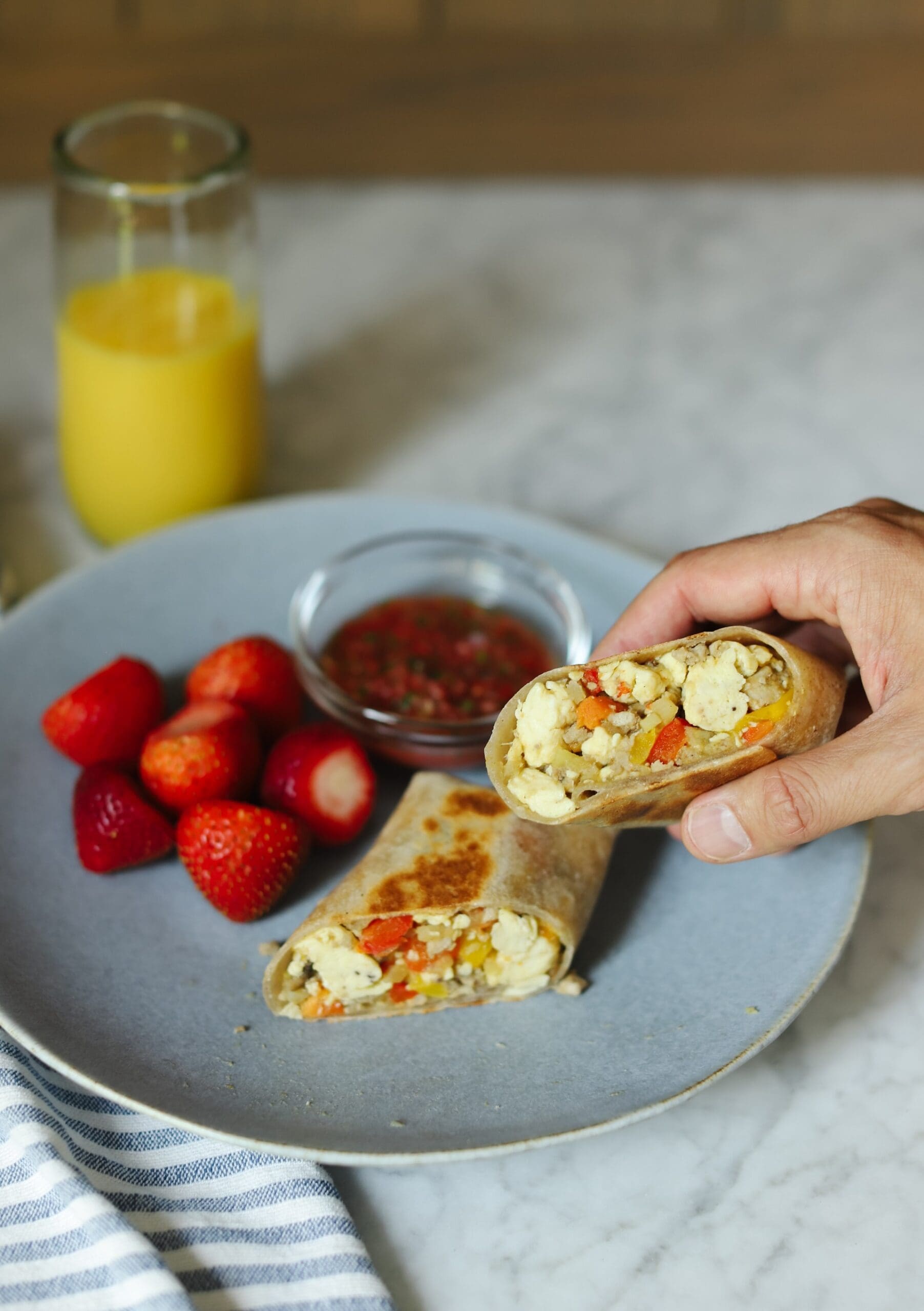 Chris Loves Julia | Chris holding a breakfast wrap