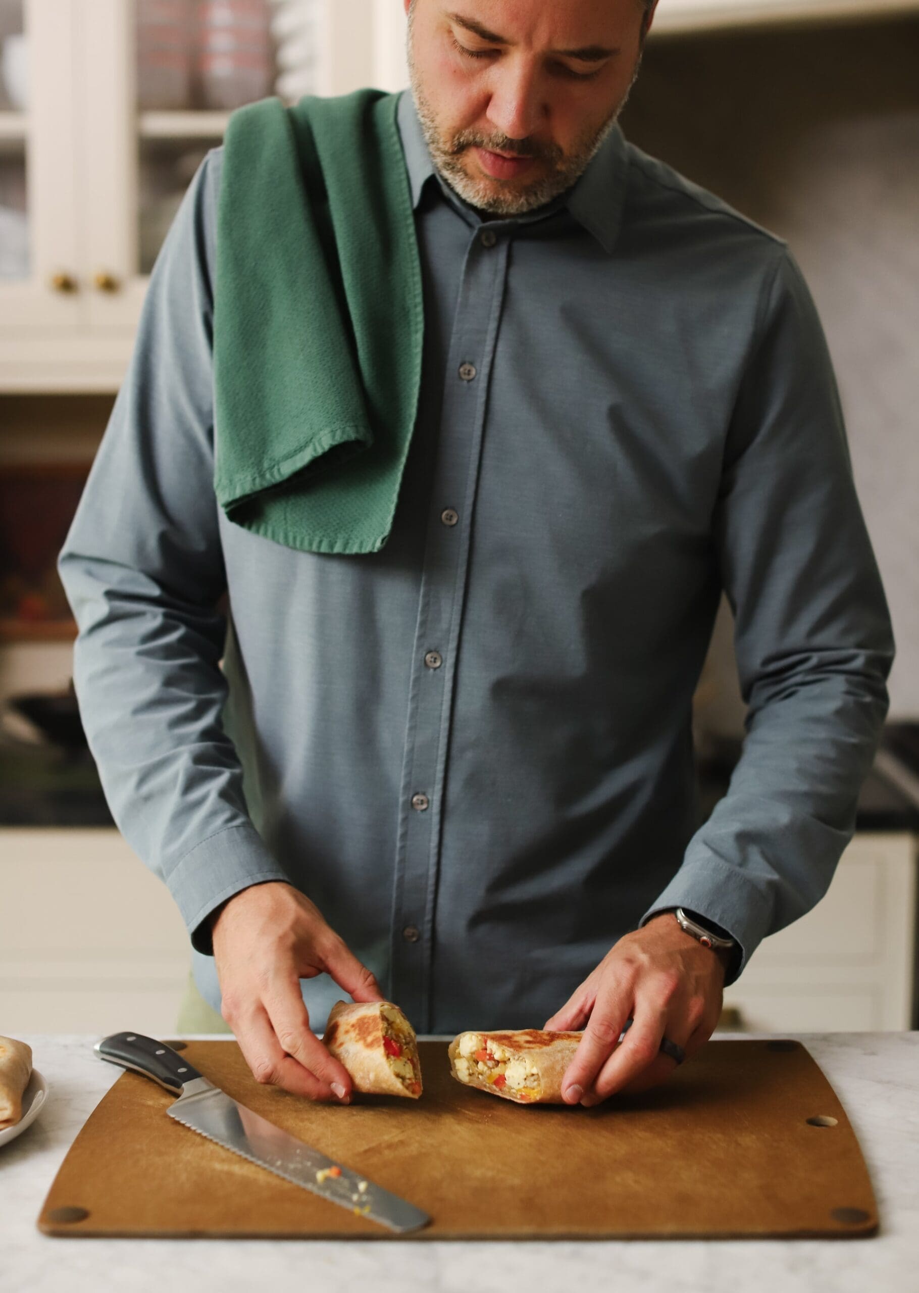 Chris Loves Julia | Chris holding a breakfast wrap on a cutting board