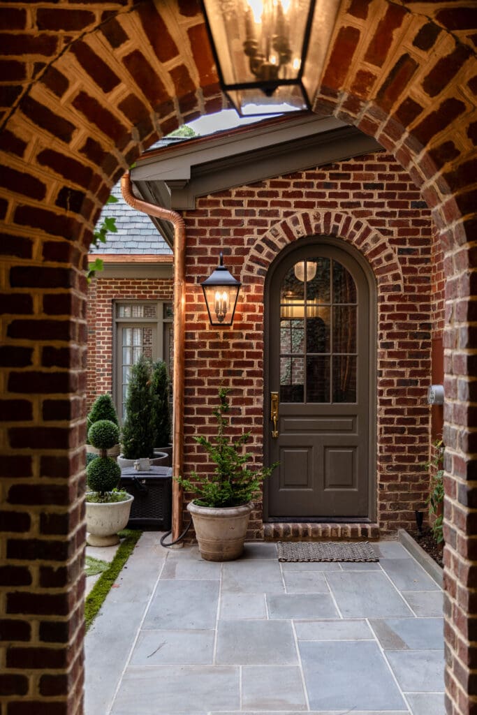 Mud room entrance with potted plants next to the door