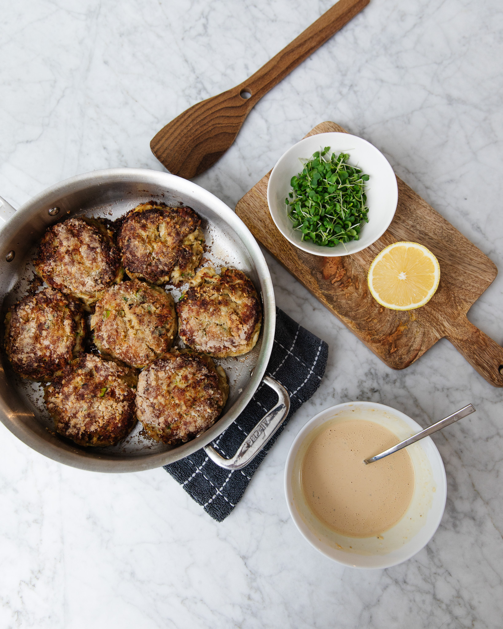 Chris Loves Julia | Crab cakes with easy remoulade sauce and a board of a lemon and microgreens