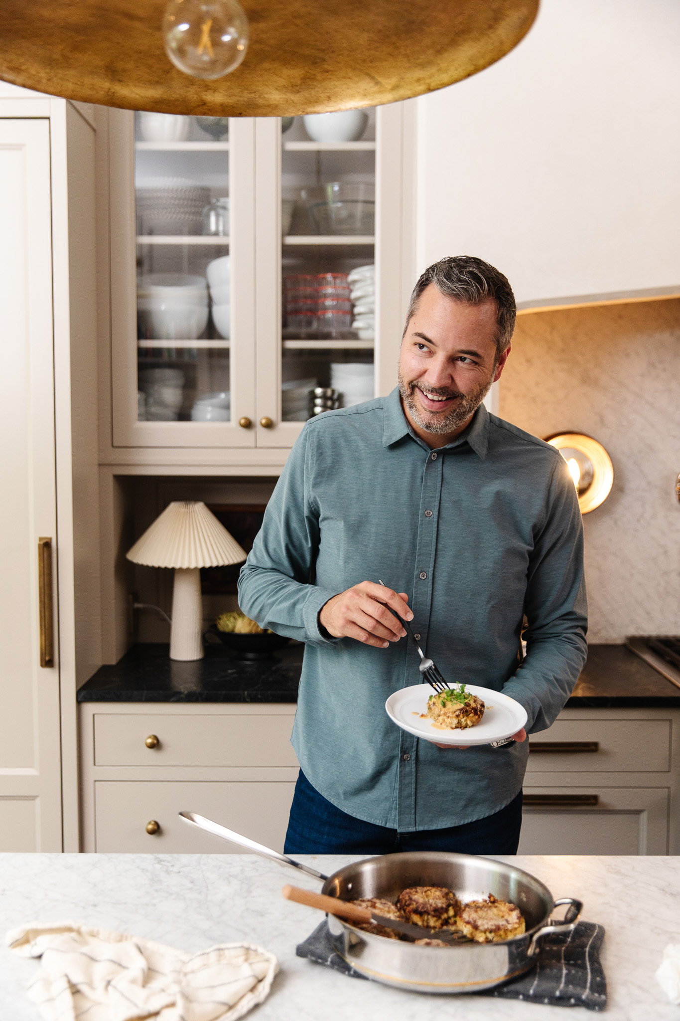 Chris Loves Julia | Chris holding a plate of crab cakes with easy remoulade sauce