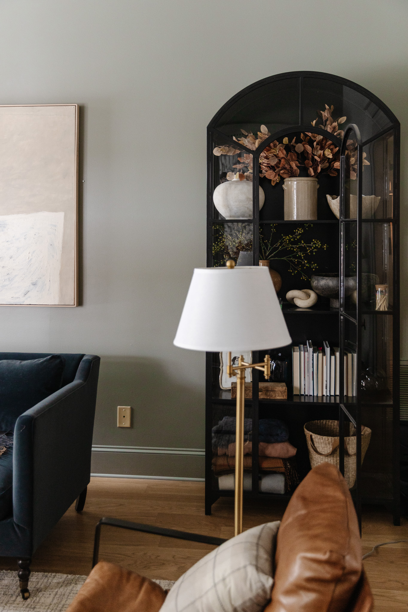 Chris Loves Julia | Black credenza with rusty fall stems in a vase.