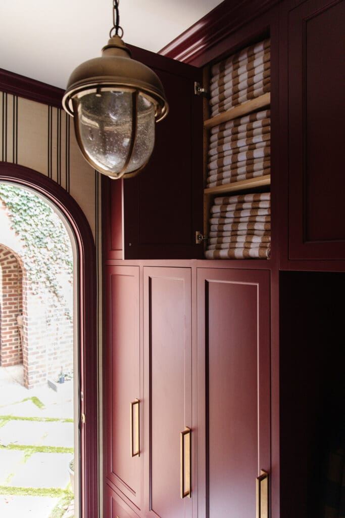 Red cabinetry in the mudroom with a white ceiling