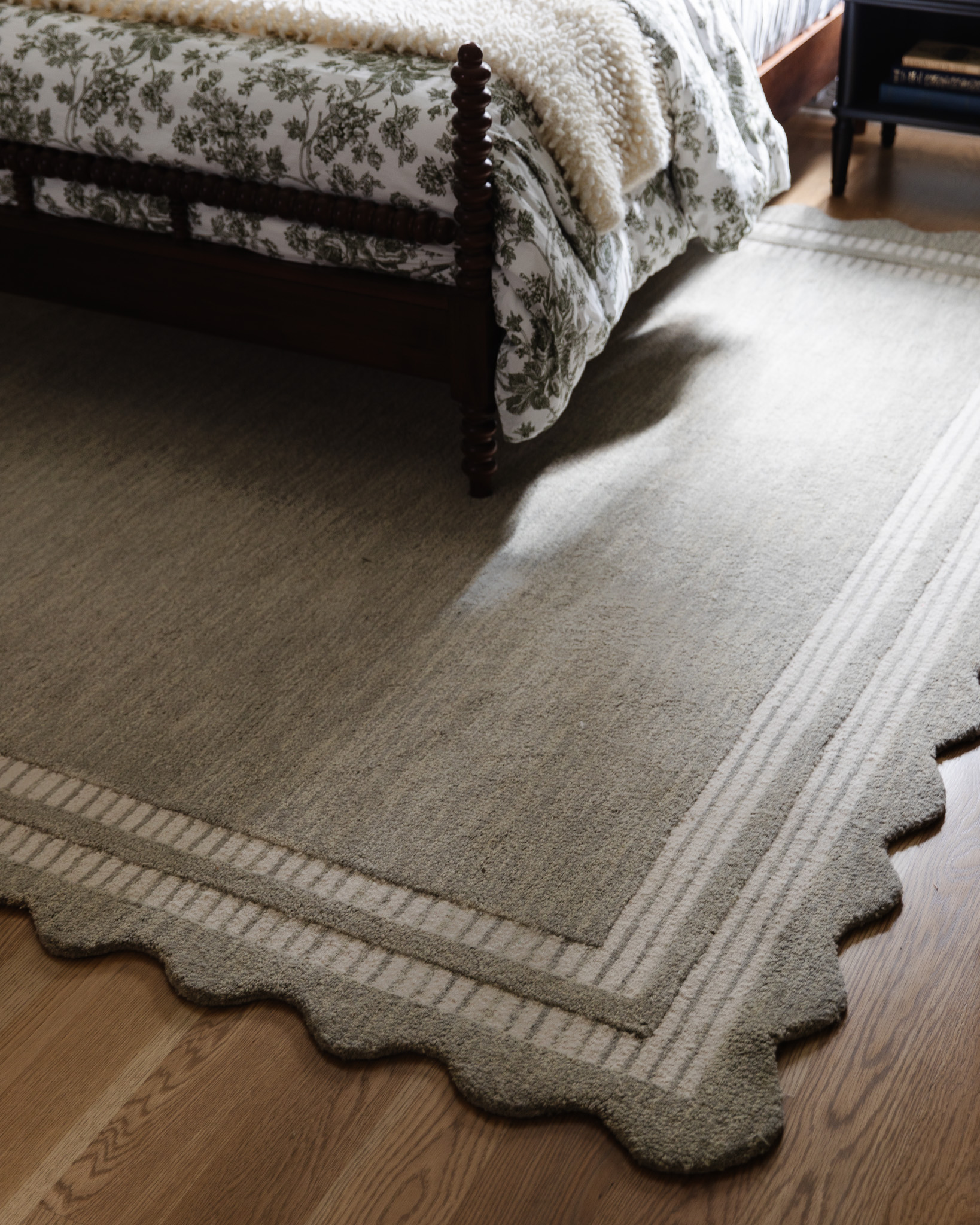 Overhead view of scallop-edge Loloi rug with framing stripe in blue-gray color