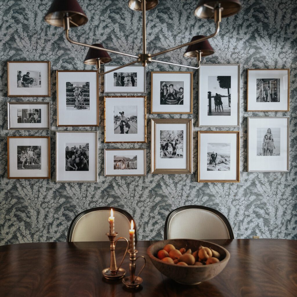 A gallery wall of antique gold Framebridge frames filled with B&W photos