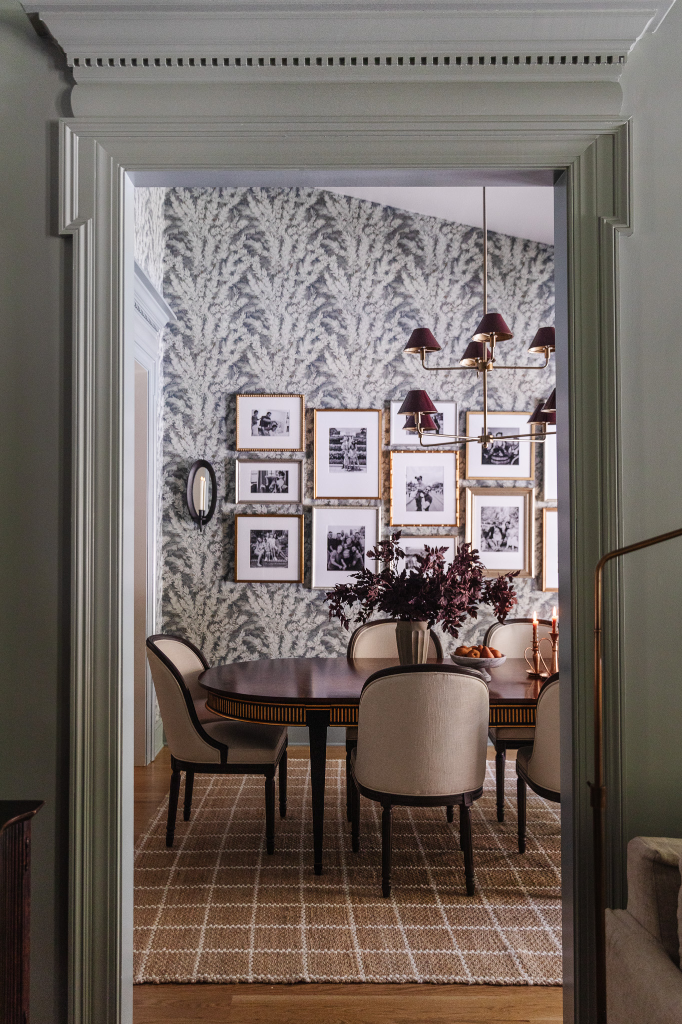 View through a door into a dining room with a jute & wool brown-and-white grid rug