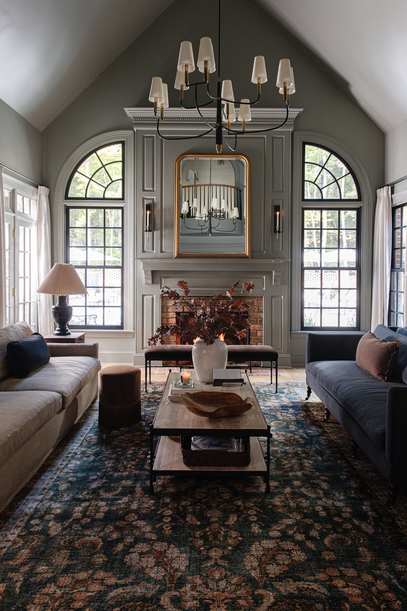 Living room with two facing couches and a vintage-looking navy and red rug