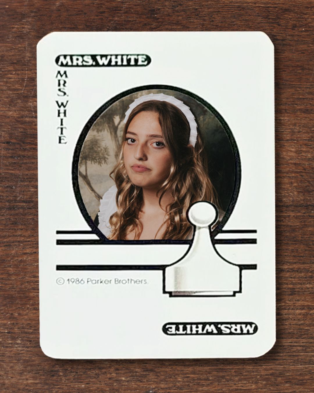 Girl dressed as Mrs. White on a classic playing card from Clue: The Game.