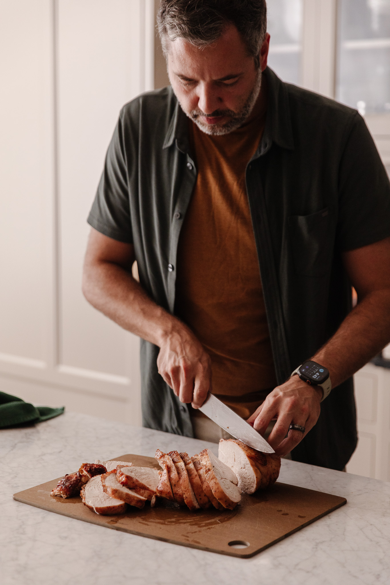 Chris carving a turkey breast into thick slices