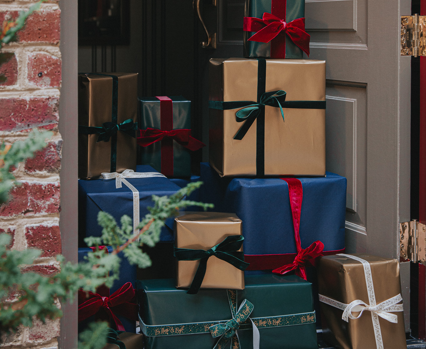 Beautifully wrapped traditional presents stacked in a doorway