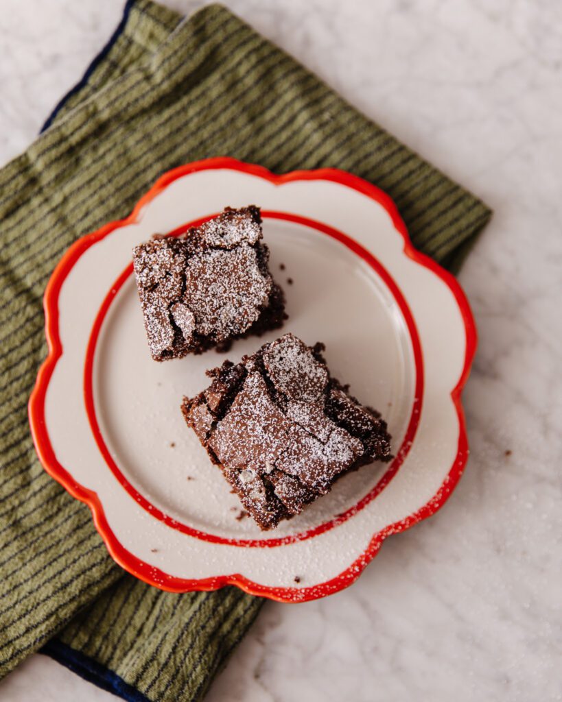 Two brownies on a festive red and white plate