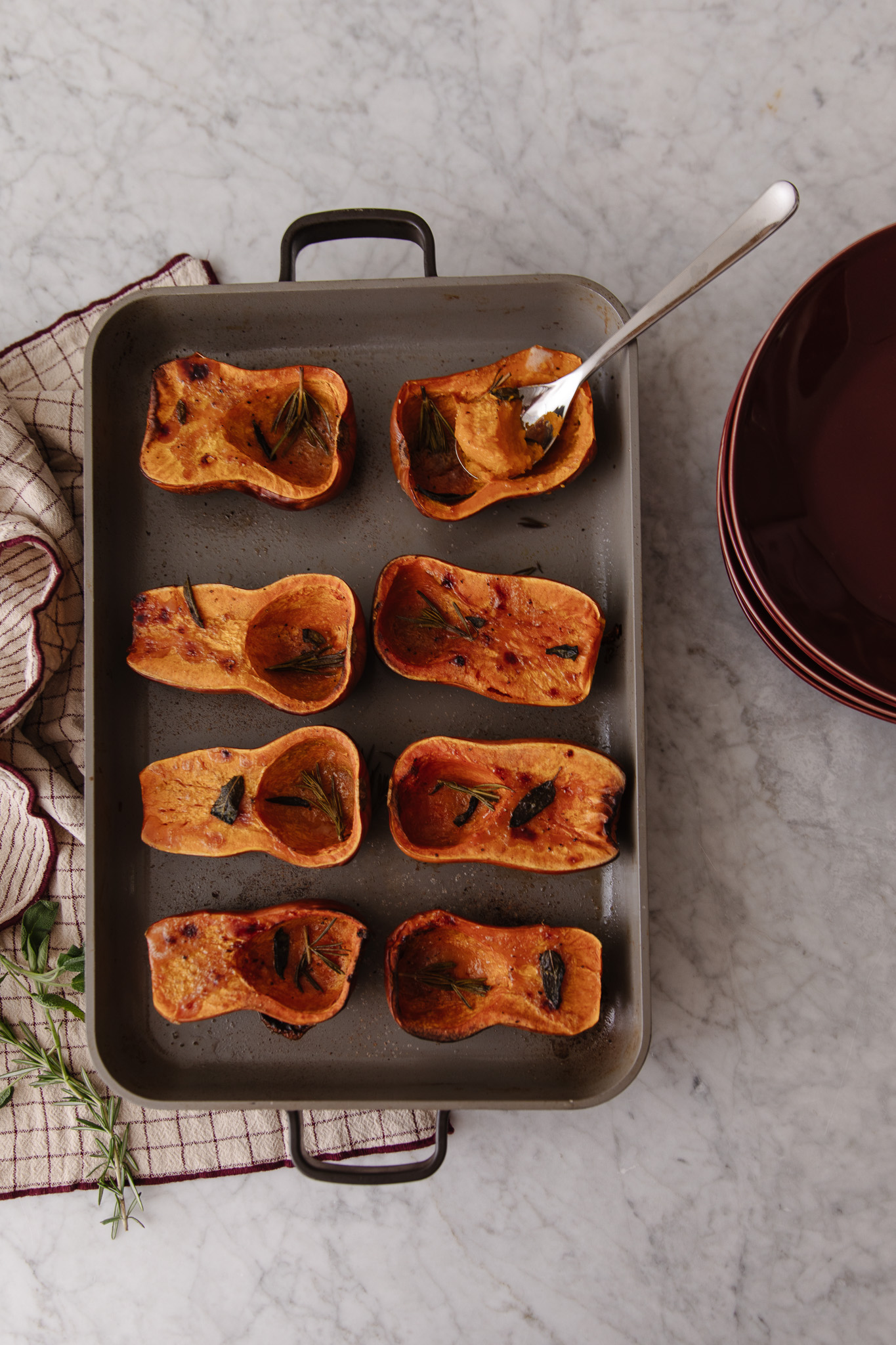 Overhead of roasted honeynut squash halves on a pan