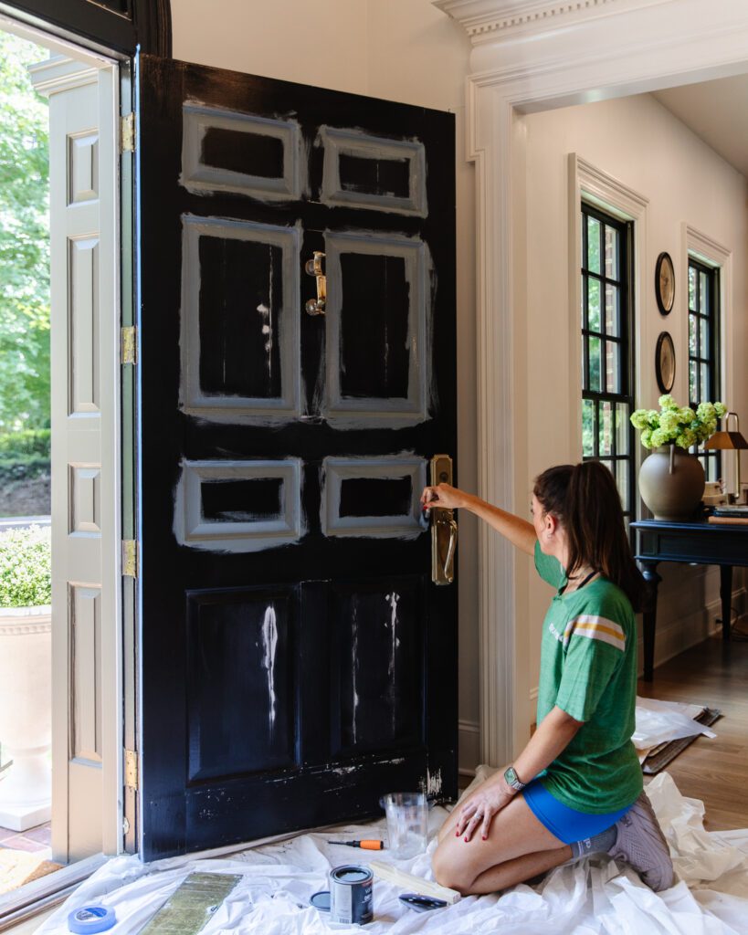 Julia painting the black front door a smoky blue color