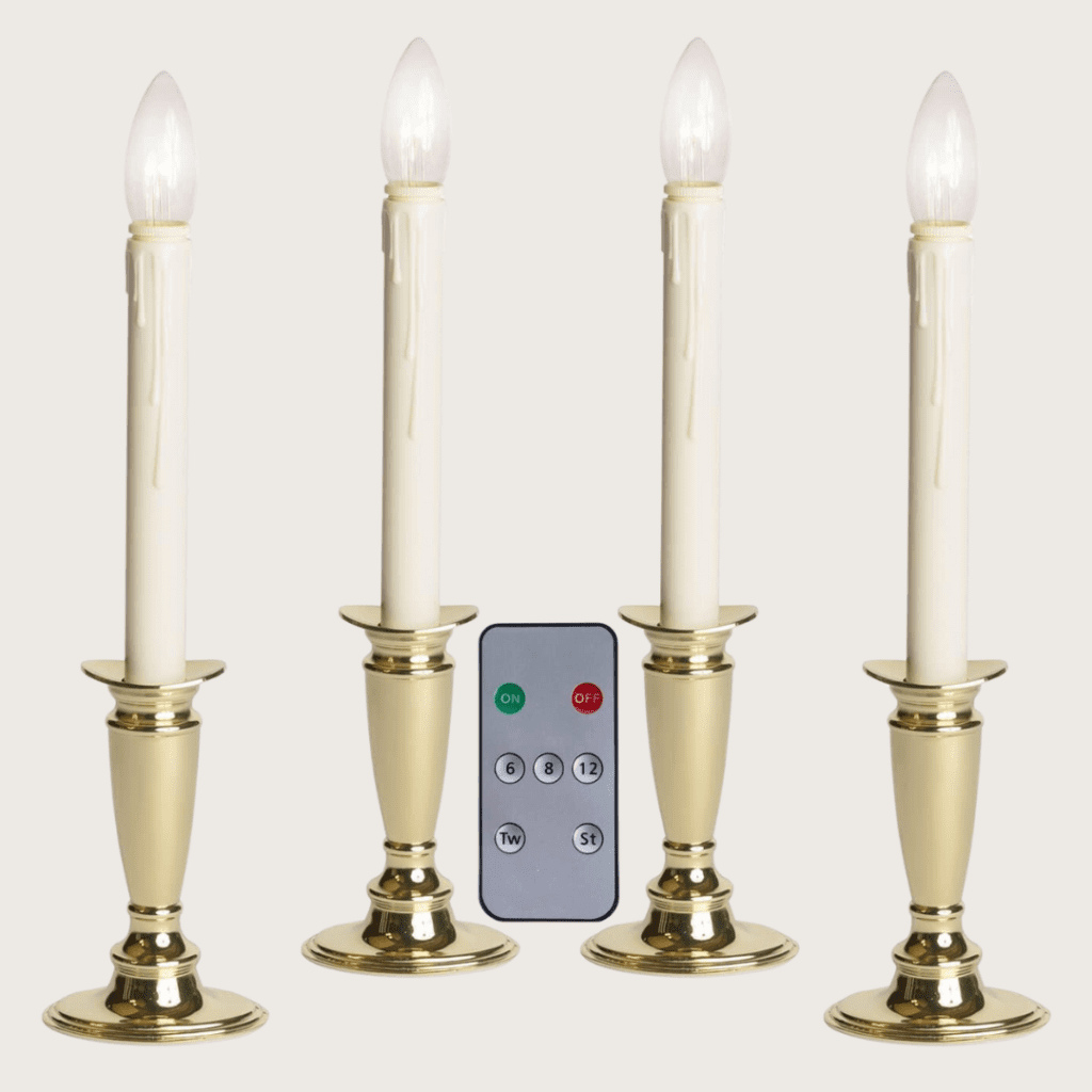 4 window candles with tall cream and gold bases and a remote