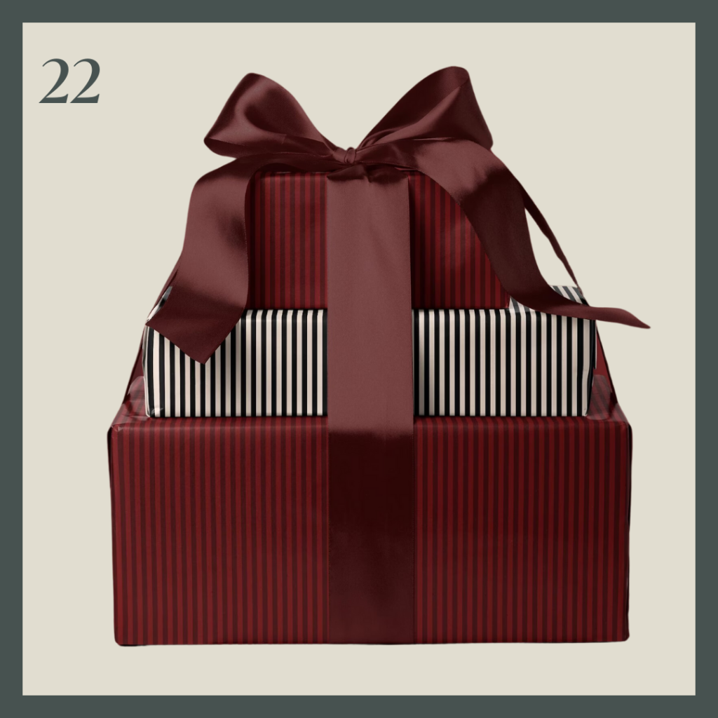 A stack of three presents in burgundy stripe and white